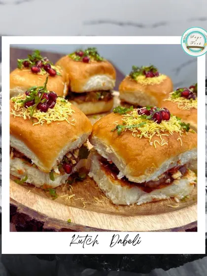 Presenting Kutch Dabeli, a popular street food from Gujarat. It's a soft pav stuffed with a tangy and spicy potato filling, garnished with sev and pomegranate seeds.