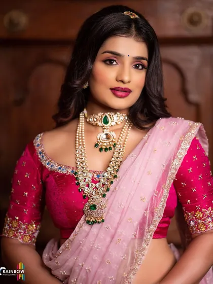 An identical portrait, offering a crisp view of the jewelry and blouse details.