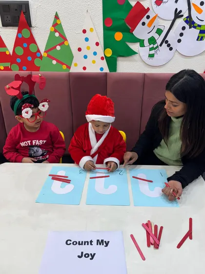 Even our little reindeer and Santas are busy learning. This photo captures the fun and festive atmosphere of our holiday-themed educational activities.