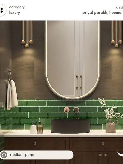 A luxury powder room design for our client Rasika in Pune, featuring bold green subway tiles, a dark wood vanity, and elegant wall sconces for a dramatic and moody vibe.