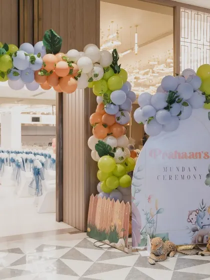 The entrance to Prahaan's Mundan ceremony, with a jungle-themed welcome sign and a colorful balloon arch.