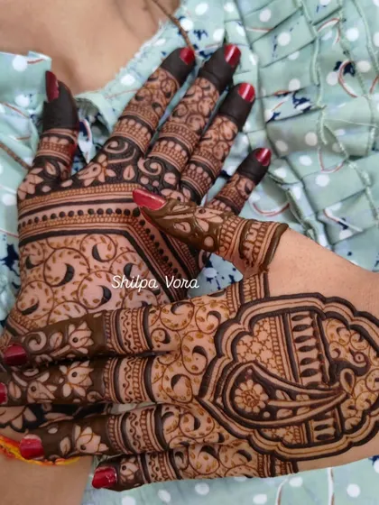 A creative pose showing two different back-hand designs for guests.