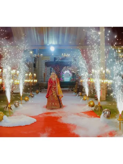 The bride's grand entrance with sparklers lining the aisle.