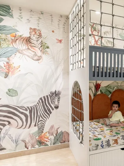 Designing for children is about sparking imagination. This jungle-themed bedroom features a custom bunk bed that doubles as a play area, with integrated storage in the steps. It's a fun, vibrant, and functional space designed to grow with the child.