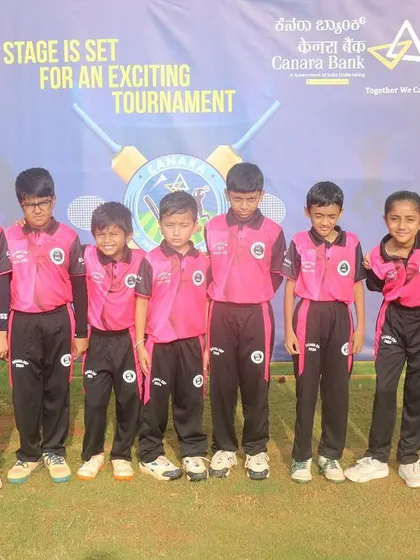 A full line-up of one of our U-10 teams in front of the official tournament banner.