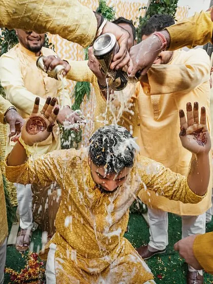The groom's Haldi gets a fun twist with friends showering him with beer. It's all about the masti!