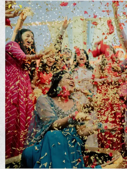 A moment of pure joy for the bride. Surrounded by her friends and a shower of flower petals, Saloni's laughter is infectious in this beautiful, candid Haldi shot.