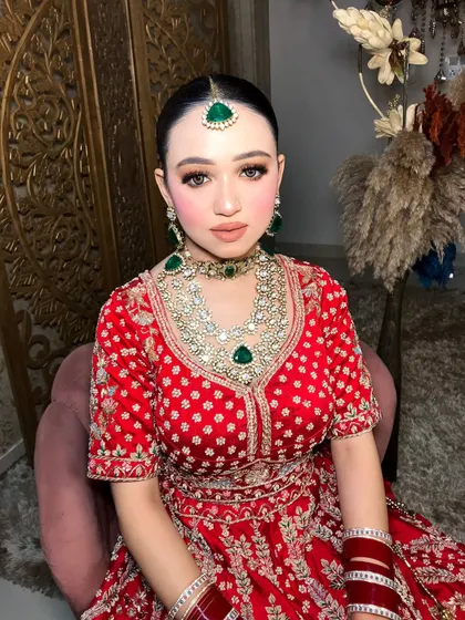 Seated and poised, this shot shows how the makeup looks stunning from every angle.