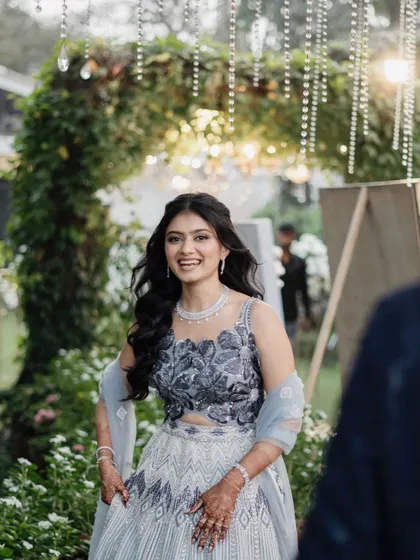 A joyful, candid shot of the bride. Her makeup is fresh and radiant, perfect for a garden party engagement.