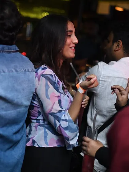 Friends enjoying a conversation amidst the party. It's a social club, after all.