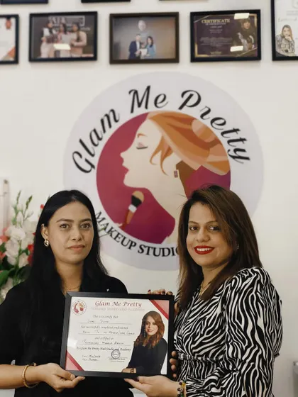 Handing over a certificate to another successful student. Her hard work and talent are sure to take her far in her new career.