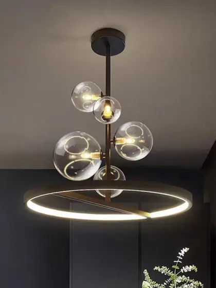 A contemporary chandelier combining a black ring with clear glass globes. This design offers a balanced mix of industrial and elegant styles.