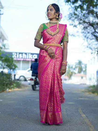 A full-length shot showcasing how our rental temple jewellery complements a vibrant silk saree, perfect for a wedding ceremony.