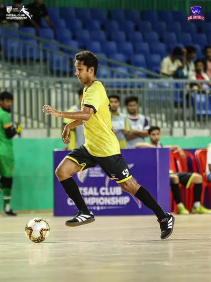 A player running with the ball, looking to start an attack.