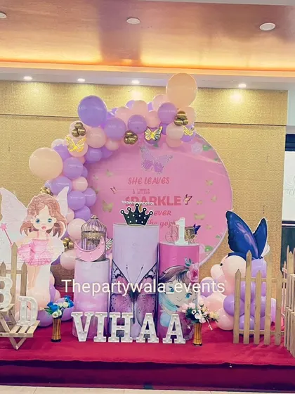 A fairy tale theme with a 'She leaves a little sparkle' backdrop, set on a stage for a grand celebration.