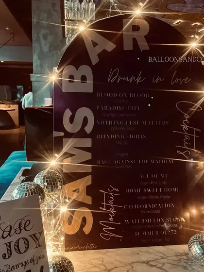 The custom bar menu for 'Sam's Bar', with cocktail and mocktail names inspired by famous rock songs.