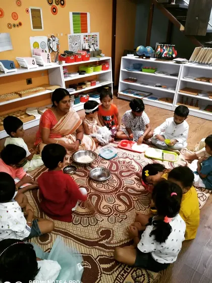 Children gathered together to prepare a traditional sweet for Diwali. Group activities like this foster a sense of community and cooperation, as they all contribute to creating something special for the celebration.
