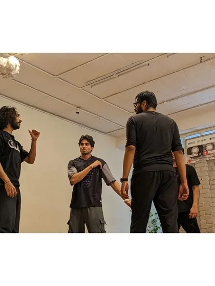 An intense discussion about a movement sequence, showcasing the collaborative nature of our classes.