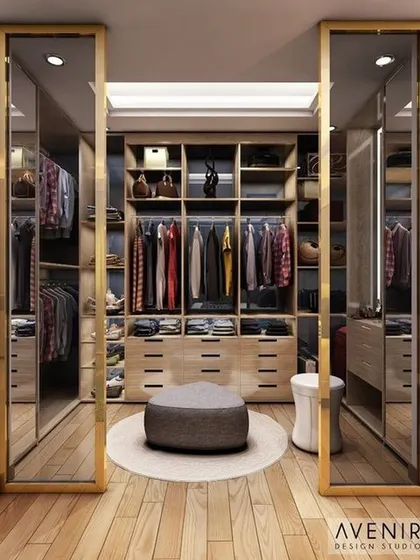 A well-organized and luxurious walk-in closet. This visualization highlights custom cabinetry, ample storage, and elegant finishes like gold-framed mirror doors.
