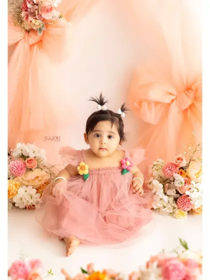 Isn't she just a doll? This is a perfect example of the classic portrait part of my session. In a beautiful dress against a soft, floral backdrop, her personality shines through. These are the timeless photos that capture just how little they are at one.