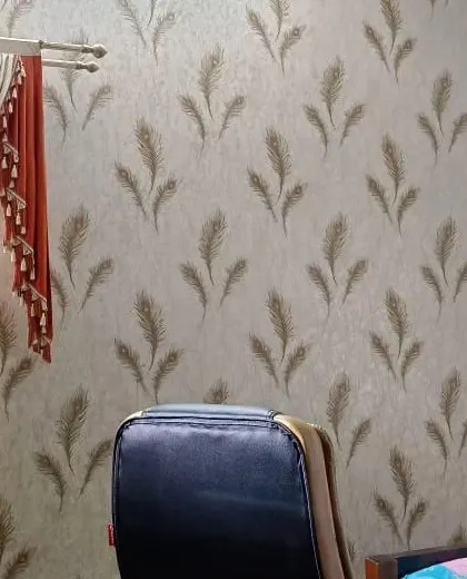 An office space with a peacock feather wallpaper, adding a touch of elegance and creativity to the work environment.