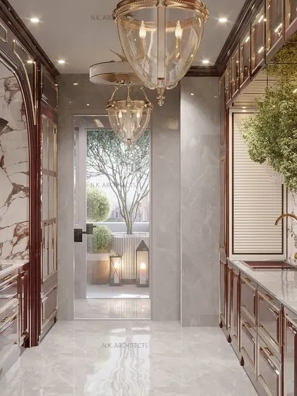 This galley-style kitchen in a rich maroon finish opens up to a beautiful terrace. The classical design, with its detailed cabinetry and elegant light fixtures, creates a warm and inviting atmosphere.