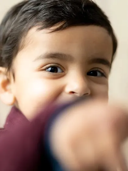 A close-up portrait capturing the bright, curious eyes of a young boy during his studio session.