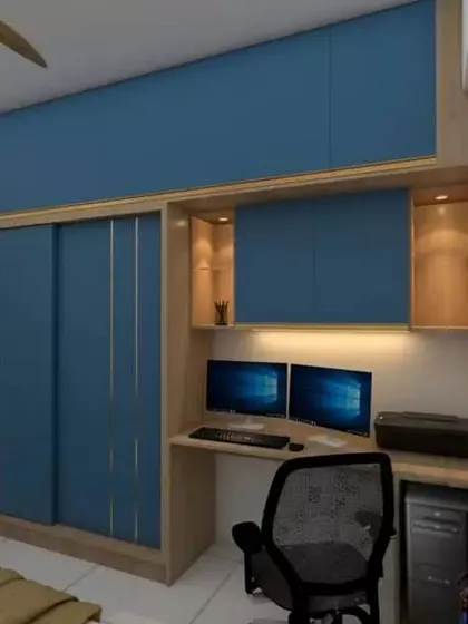 This bedroom at United Blossoms features a built-in wardrobe and study unit in a striking blue, maximizing storage and creating a dedicated workspace.