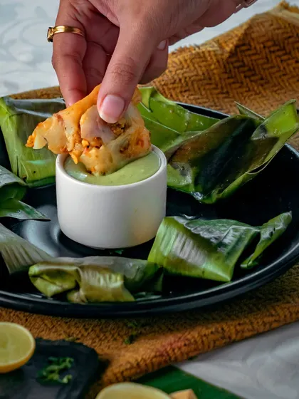Ever tasted the magic of steamed Pomfret in Banana Leaves? Wrapped in nature's goodness with a splash of lemon, this dish is a flavour revelation.