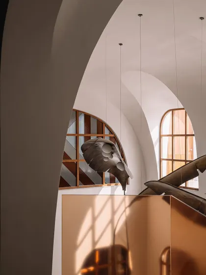 A view of the grotto-like architecture, with its layers of arches and curves, creating a dynamic play of light and shadow.