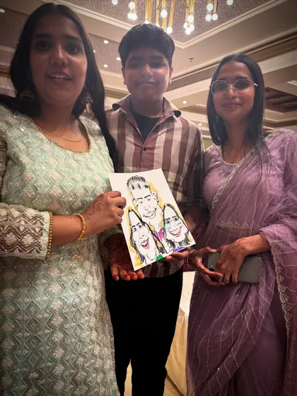 A group of friends or family posing with their fun group caricature.