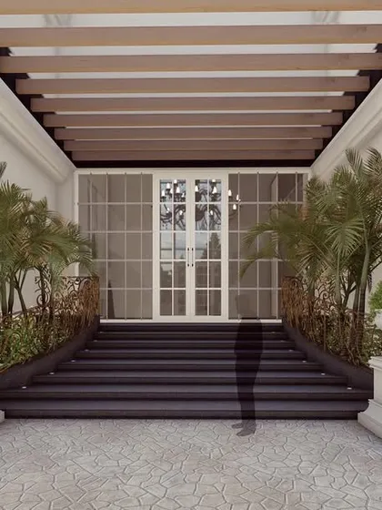 A closer look at the welcoming entrance of "The Clarence." The combination of a wooden pergola, classical planters, and elegant lighting creates a warm and sophisticated point of entry.