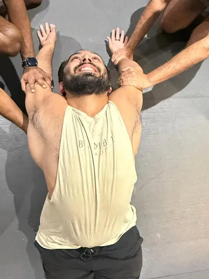 This is the face of a good stretch. Partner-assisted thoracic work can feel intense, but it's incredibly effective for releasing tension in the upper back.