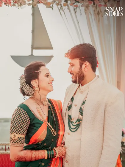A sweet moment between the couple, framed against a nautical-themed backdrop. We love finding unique angles and settings for your wedding portraits.