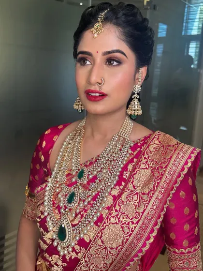 A close-up of the regal makeup, with a bold red lip and beautifully defined eyes.