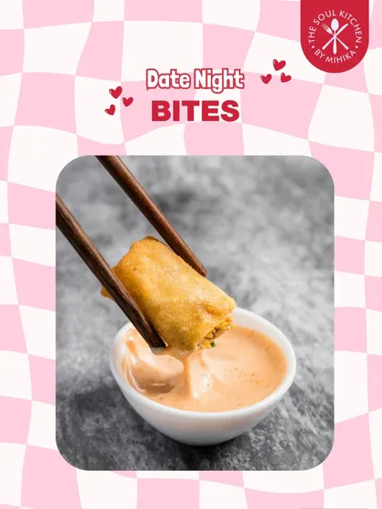 A crispy spring roll being dipped into a creamy sauce, another perfect bite-sized appetizer for a special evening.