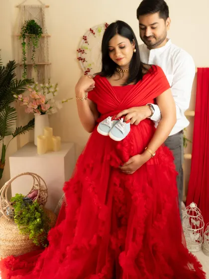A sweet detail shot of the couple holding baby shoes over the bump. It's a creative way to announce the upcoming arrival.