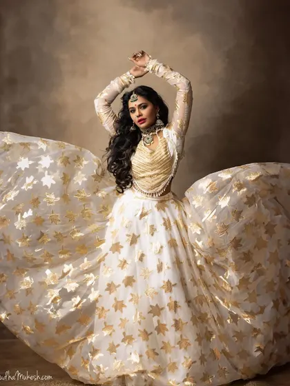 The full, dramatic sweep of the lehenga paired with the bold jewellery creates a truly unforgettable image.
