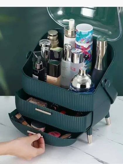 A view of the green vanity organizer with its drawers open, showing the ample storage space for makeup palettes, brushes, and other essentials.