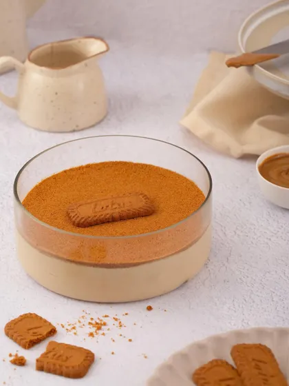 Our Biscoff Tiramisu in a serving bowl, showcasing its smooth top layer of Biscoff crumb. This dessert is a modern twist on a classic favourite.