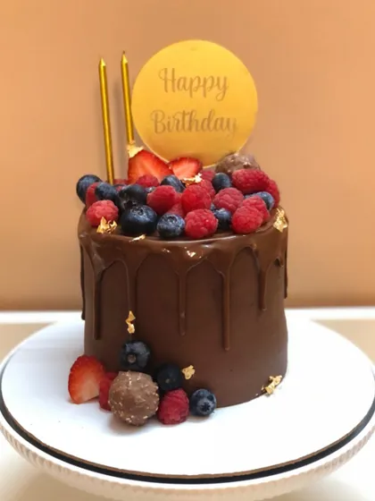 A rich chocolate drip cake loaded with fresh berries. It's the perfect balance of indulgence and freshness.