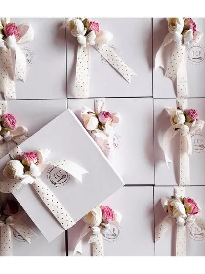Every arrival deserves a touch of sweetness. Our baby announcement hampers are curated with care, like these white boxes adorned with polka-dot ribbons and delicate flowers.