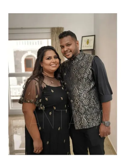 A closer look at the couple's coordinated outfits. I designed his black brocade Bundi jacket to match the subtle embroidery on her black net cape gown.