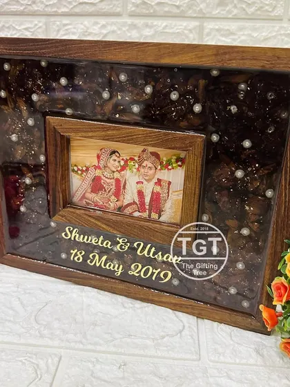 This 8x10 inch teakwood frame features a smaller, inset wooden frame for the photo, creating a layered, three-dimensional effect.