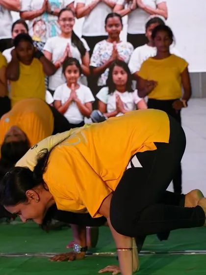 Students demonstrate their mastery of Bakasana (Crow Pose) during a public performance.