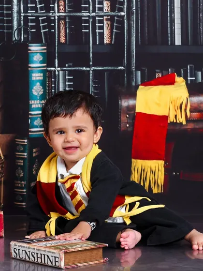 A quiet, happy moment in the common room. This little Gryffindor is content exploring the magical books and props in the studio.