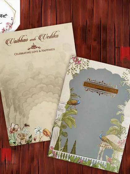 A sophisticated Pichwai invitation with peacocks perched in a lush garden, set against a subtle grey background for a touch of modern elegance.