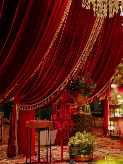 A detail of the rich, red velvet drapery with gold tassel trim. This shot emphasizes the quality of materials and the attention to detail that create a truly luxurious atmosphere.