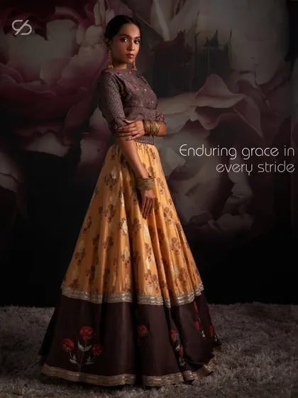 Enduring grace in every stride. This Haldi-inspired lehenga combines earthy tones with floral prints for a look that is both traditional and modern.