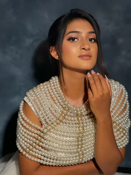 A portrait from my advanced workshop, showcasing a modern bridal look. The monotone pink makeup and the unique pearl cape create a fresh and artistic style.